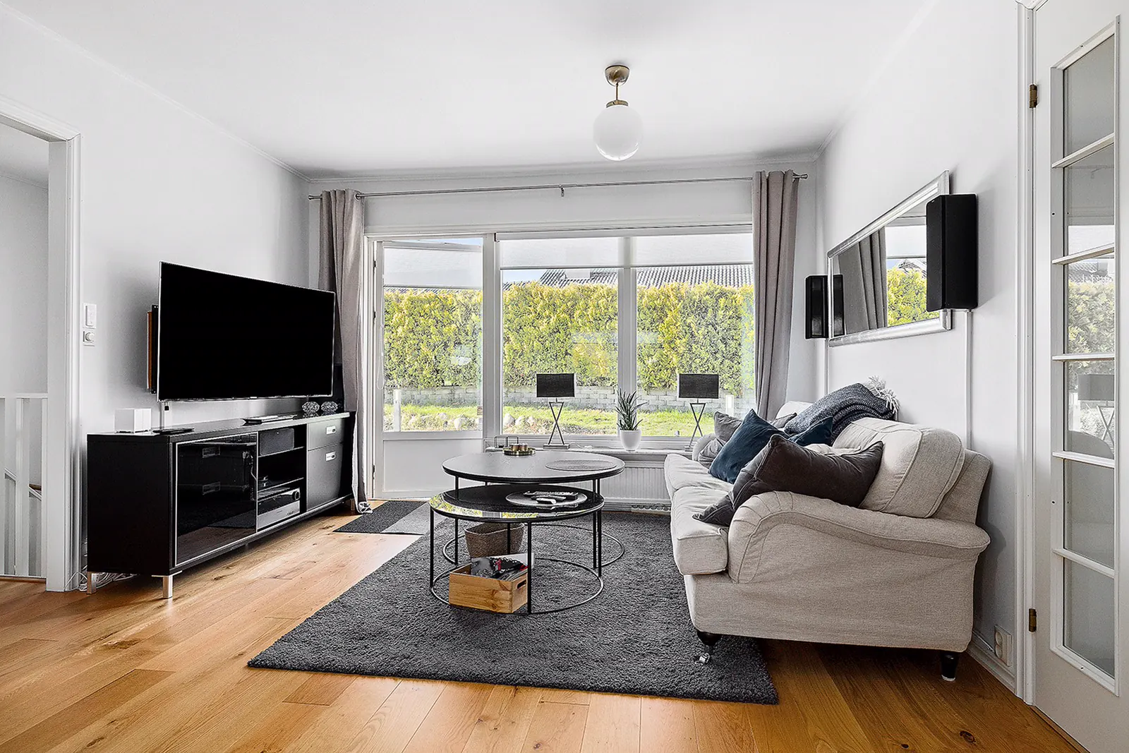 Living room with a sofa and TV in a furnished corporate apartment